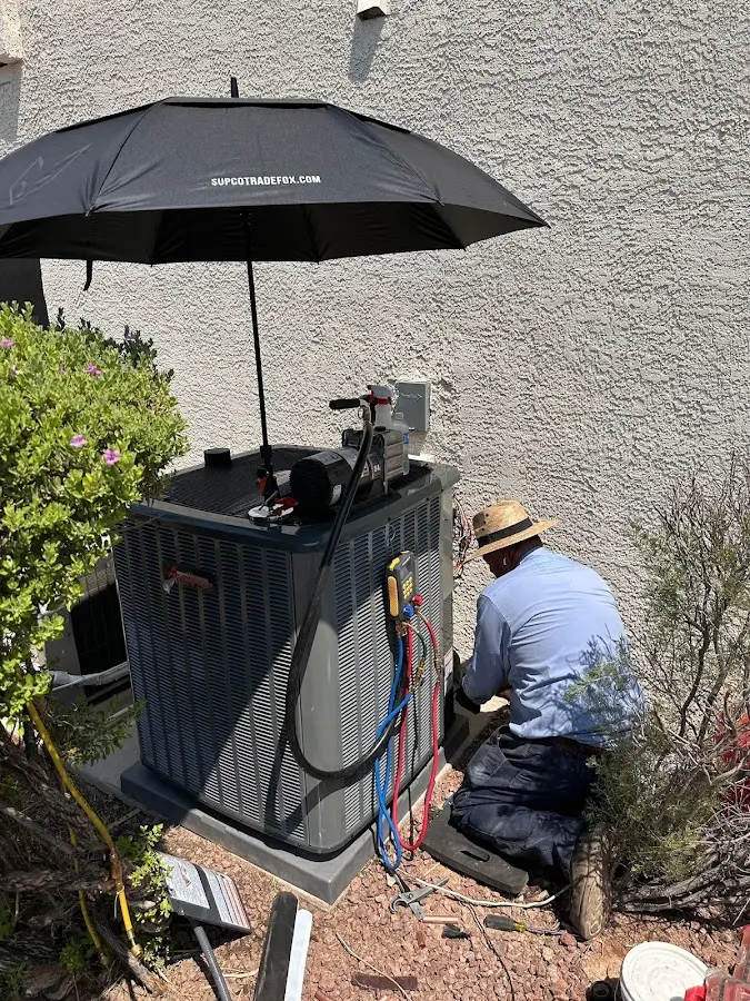 HVAC technician performing outdoor AC maintenance in Los Altos Hills